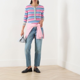 Model wearing Max&Co Giunto Stripe Henley Top in Pink Pinstripes, styled with blue jeans, pink tied cardigan, and black loafers