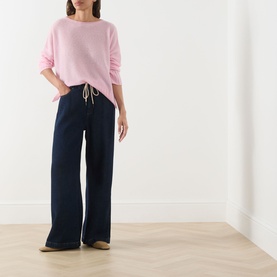 Model wearing Max&Co Stampa Knit Sweater in pink plain with boat neckline, styled with navy wide-leg drawstring trousers.
