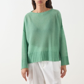 Model wearing Max&Co Stampa Knit Sweater in green plain with boat neckline, dropped shoulders and ribbed trims, styled with white trousers