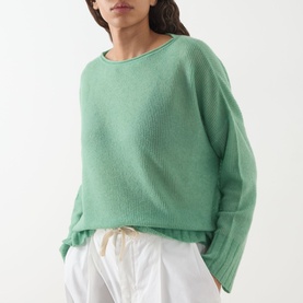 Model wearing Max&Co Stampa Knit Sweater in green, featuring boat neckline, dropped shoulders and ribbed trims, styled with white drawstring trousers