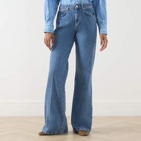 Model wearing Max&Co Liriche Mid-Rise Wide Leg Jeans in navy, five-pocket style with faded whiskering detail, styled with a blue top and tan boots