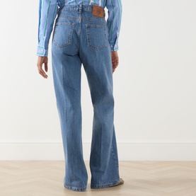 Model wearing Max&Co Liriche Mid-Rise Wide Leg Jeans in navy, showing rear view with leather logo label, five-pocket style and bootcut fit.
