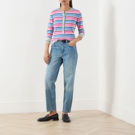 Model wearing Max&Co navy denim straight-leg jeans, styled with a pink multistripe knit top and black loafers.