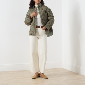 Model wearing Max&Co milk cotton trousers, styled with an olive quilted shirt jacket and tan suede loafers.