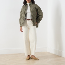 Model wearing Max&Co Milk cotton trousers, styled with an olive quilted jacket, white shirt and brown belt