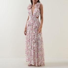 Model wearing Anne Louise Boutique pink floral maxi dress with deep V-neck, ruffle shoulders, and cinched waist
