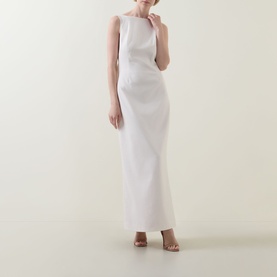 Model wearing Anne Louise Boutique Rose Bow Dress in rose, sleeveless maxi with high neckline, styled with nude heeled sandals