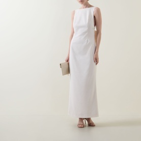 Model wearing Anne Louise Boutique Rose Bow Dress in rose, sleeveless maxi with high neckline, styled with nude heeled sandals and clutch bag.