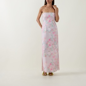 Model wearing Bernadette strapless maxi dress in Clematis Montana Pink floral print with side split, styled with gold sandals