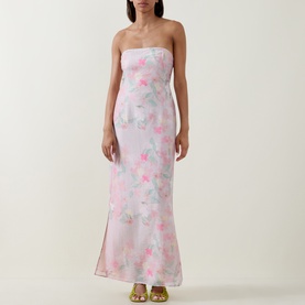 Model wearing Bernadette strapless maxi dress in Clematis Montana Pink floral organza, styled with gold strappy heels.