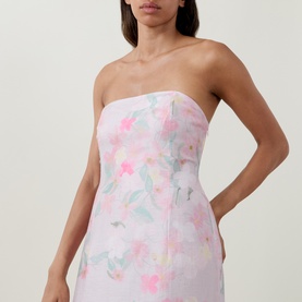 Model wearing Bernadette strapless mini dress in Clematis Montana Pink floral print with pastel blooms on white ground.