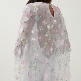 Model wearing Bernadette dress in Clematis Emb White, sheer floral embroidered overlay with pastel pink blooms and green leaf detail, keyhole back