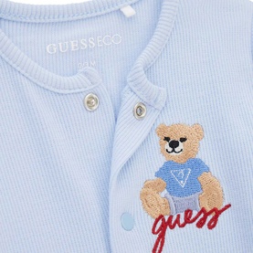 Guess Smart Blue ribbed baby romper close-up showing embroidered teddy bear in blue top with red cursive Guess logo