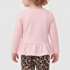 Model wearing Guess 2 Piece set in Polly Pink, long-sleeve peplum top with floral leopard print leggings, rear view.