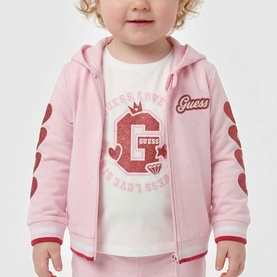 Model wearing Guess Polly Pink 2-piece set; zip-up hoodie with G logo and heart sleeve print over white graphic tee