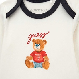 Guess 3 Piece baby set in cream with navy trim, featuring illustrated teddy bear graphic wearing red Guess top on bodysuit.