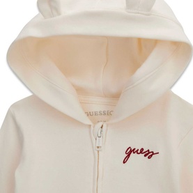 Guess cream white children's zip-up hoodie with script logo embroidery and bear ear hood detail, close-up view.