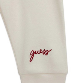 Guess children's cream white 3-piece set, close-up of red embroidered cursive Guess logo on cuffed hem.