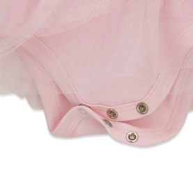 Close-up of pink baby bodysuit with tulle skirt overlay, showing silver snap fasteners at the crotch