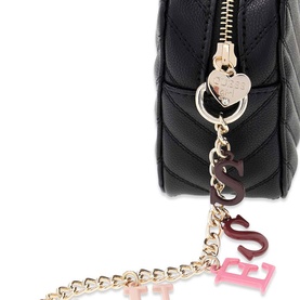 Black quilted bag close-up showing gold heart zip pull, decorative letter charms, and gold chain strap detail