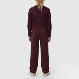 Model wearing dark burgundy cable-knit jumper, styled with matching wide-leg trousers, rear view