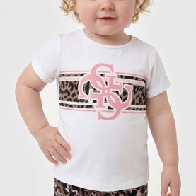 Model wearing white short-sleeve T-shirt with pink and leopard print Guess logo graphic, styled with leopard print bottoms.