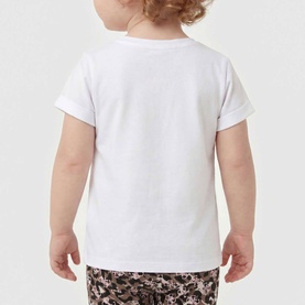 Toddler wearing a plain white short-sleeve T-shirt, styled with dark floral-print shorts, shot from behind.