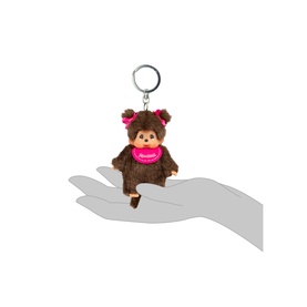 Monchhichi brown plush monkey keyring with pink bib and bow, held on fingertips to show small size
