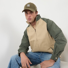 Model with New Era New York Yankees MLB 9FORTY Baseball Cap in green corduroy, curved visor, NY logo, styled with striped shirt and gilet.