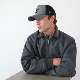 Model with New Era Truc9/40 Sport Baseball Cap in grey, two-tone design with mesh back and NY Yankees logo, paired with grey zip jacket