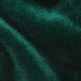 Close-up of rich emerald green velvet fabric with a lustrous sheen and soft draped texture