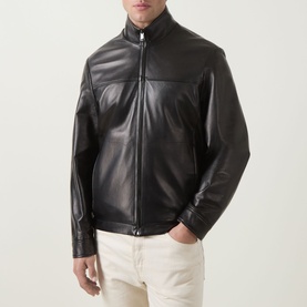 Model wearing Canali black leather casual jacket with zip fastening and stand collar, styled with white trousers