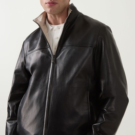 Model wearing Canali black leather casual jacket with zip fastening and contrast beige inner collar detail
