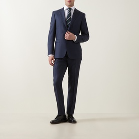 Model wearing Canali D8 Two-Piece Suit in navy, single-breasted blazer with striped tie and black dress shoes.