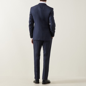 Model wearing Canali D8 Two-Piece Suit in navy wool, rear view, styled with white shirt and black shoes.