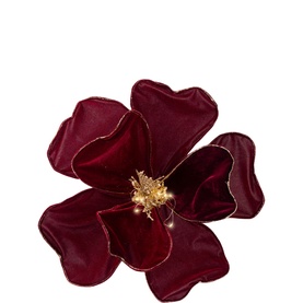 Deep red velvet magnolia flower decoration with gold-edged petals and golden stamen centre