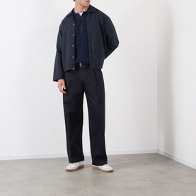 Model wearing NN07 Fenton Water Repellent Jacket in Deep Navy with matching navy trousers and white trainers.