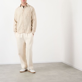 Model wearing NN07 Deon Linen Striped Shirt in Black Stripe with cream wide-leg trousers and white loafers