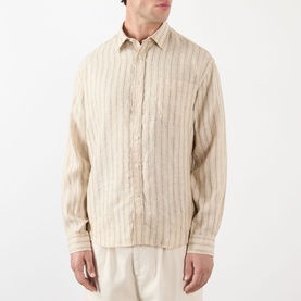Model wearing NN07 Deon Linen Striped Shirt in Black Stripe, long sleeves, point collar, front button fastening, paired with cream trousers