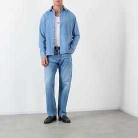Model wearing NN07 Blue Denim casual shirt with white tee, blue jeans and black loafers