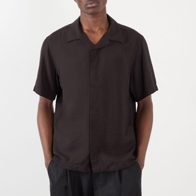 Model wearing NN07 casual shirt in Dusky Port, short sleeves, open camp collar, paired with dark trousers