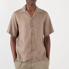 Model wearing NN07 Julio Linen Shirt in Clay Mirage, featuring camp collar, short sleeves and button fastening, styled with olive trousers.