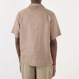 Model wearing NN07 Julio Linen Shirt in Clay Mirage, short sleeves, camp collar, back view, styled with khaki trousers