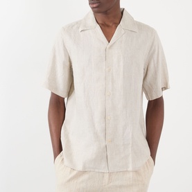 Model wearing NN07 Julio Linen Shirt in Oat, featuring camp collar, short sleeves and concealed button fastening, styled with matching linen trousers.