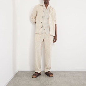 Model wearing NN07 Julio Linen Shirt in Oat with matching linen trousers and brown sandals.