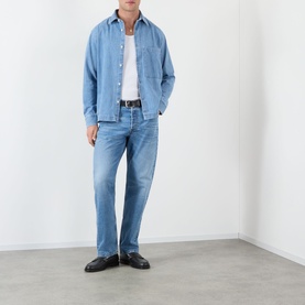 Model wearing NN07 light blue jeans in straight fit, styled with a denim overshirt, white tee, and black leather loafers.