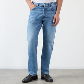 Model wearing NN07 light blue straight-leg jeans with faded wash, styled with black leather loafers