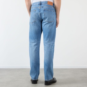 Model wearing NN07 light blue jeans, rear view, straight leg fit, worn with black loafers