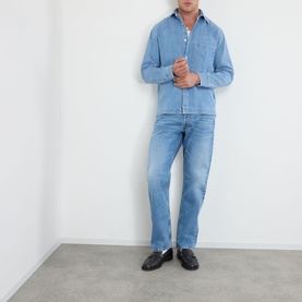Model wearing NN07 light blue straight-leg jeans styled with a matching denim shirt and black loafers