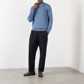 Model wearing NN07 Stone Blue linen crew neck jumper, styled with black tapered trousers and dark loafers.